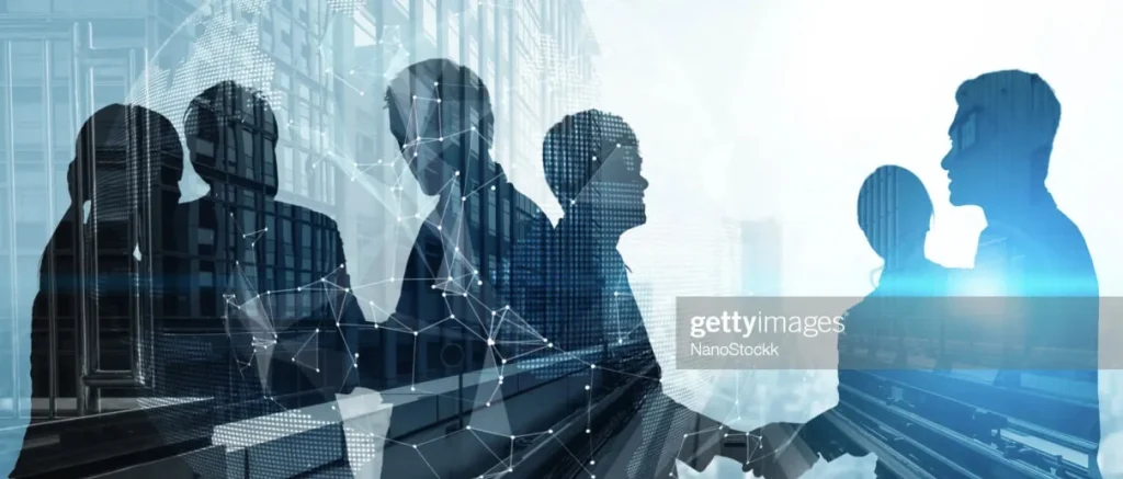 Silhouette of colleagues overlaying a building